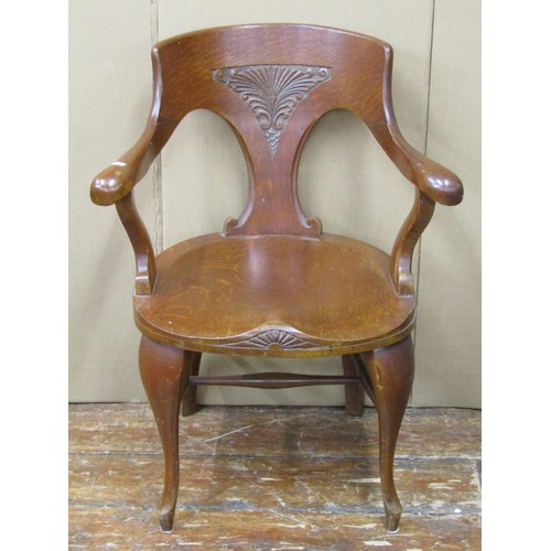 1474 - A late 19th century office chair in oak with dished seat and carved back