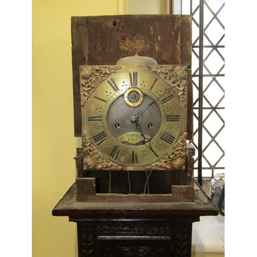 1475 - An 18th century longcase clock, the oak casework with later carved detail, enclosing a square brass ... 