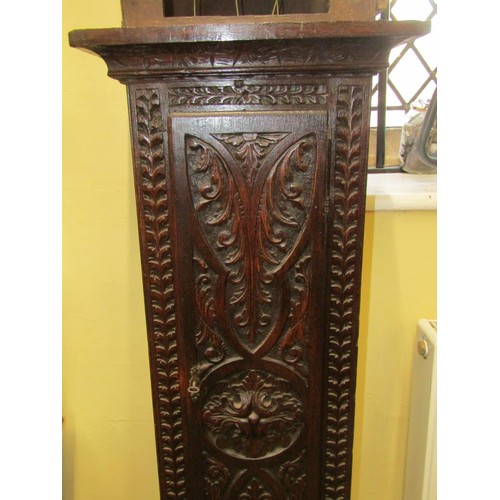 1475 - An 18th century longcase clock, the oak casework with later carved detail, enclosing a square brass ... 