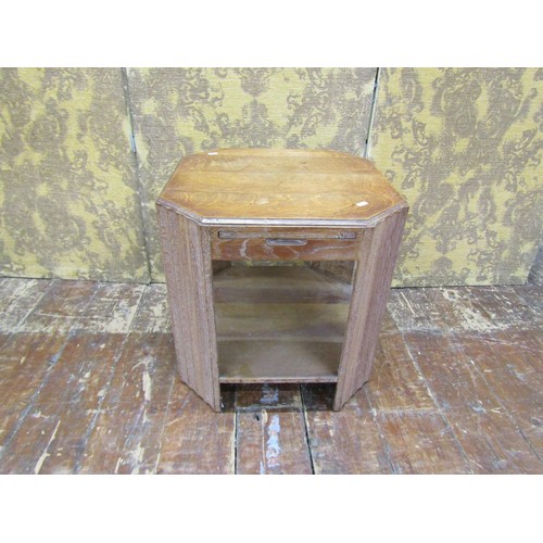 1477 - A limed oak side table of octagonal form, enclosing four sliding shelves, 51cm max