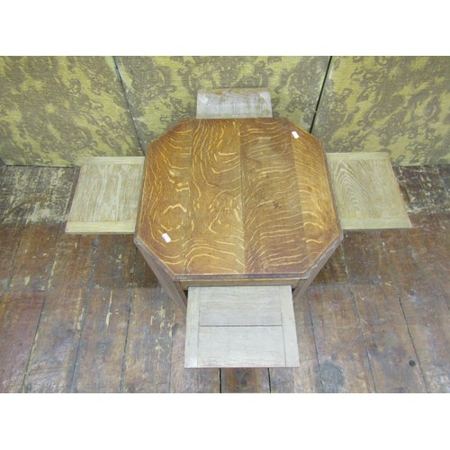 1477 - A limed oak side table of octagonal form, enclosing four sliding shelves, 51cm max