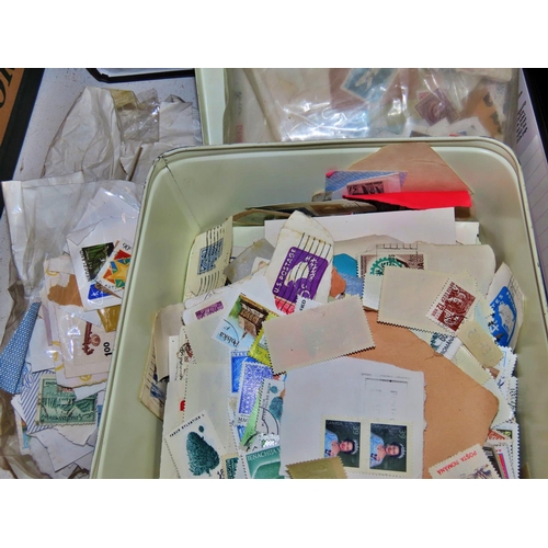 623 - Two tins of unsorted stamps together with a collection of First Day Covers