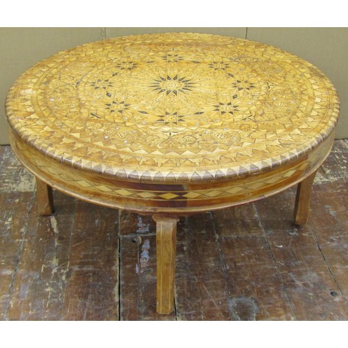 1436 - An Eastern marquetry inlaid occasional table in various woods and mother of pearl, raised on four sh... 