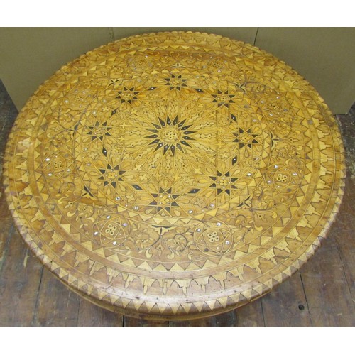 1436 - An Eastern marquetry inlaid occasional table in various woods and mother of pearl, raised on four sh... 