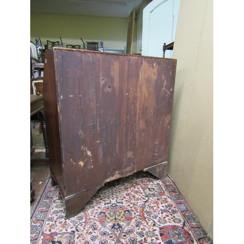 1380 - A Georgian mahogany bureau with inlaid detail of four long graduated drawers, the fall flap enclosin... 