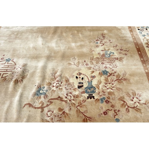 1603 - A Chinese wool carpet with flowers and vases on a cream ground and floral borders 380cm x 280cm appr... 