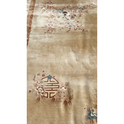 1603 - A Chinese wool carpet with flowers and vases on a cream ground and floral borders 380cm x 280cm appr... 