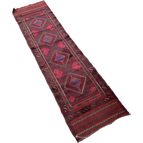 1604 - A Meshwani runner with four red and blue diamond medallions 246cm x 55cm approximately