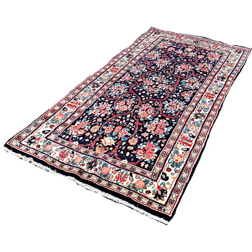 1607 - North West Persian Sarouk rug, with an all over floral pattern on a blue ground 250cm x 130cm approx... 