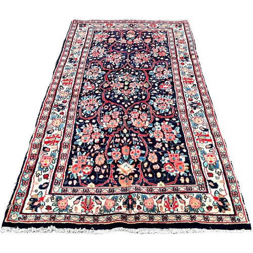 1607 - North West Persian Sarouk rug, with an all over floral pattern on a blue ground 250cm x 130cm approx... 