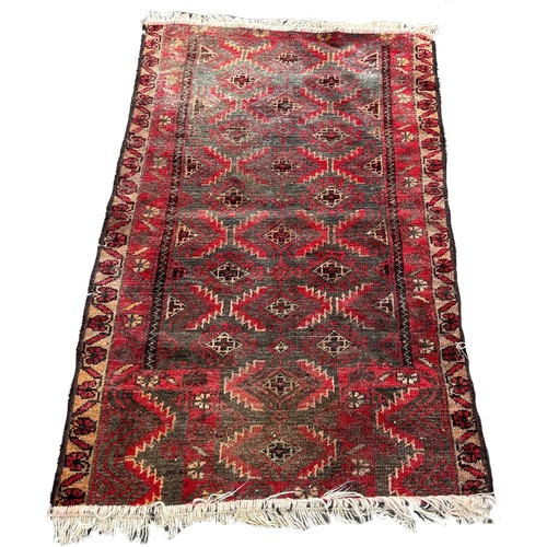 1612 - An old Middle Eastern rug with alternating rows of geometric medallions 135cm x 80 approximately