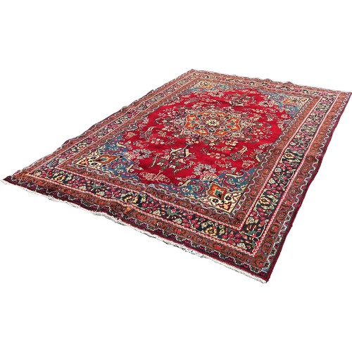 1613 - North West Tabriz carpet, with a central floral medallion on a red ground and floral borders 290cm x... 