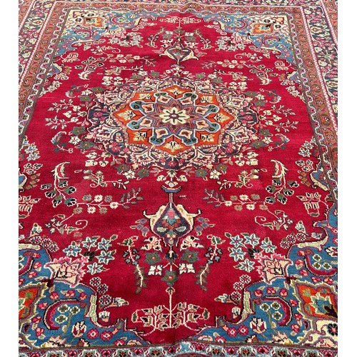 1613 - North West Tabriz carpet, with a central floral medallion on a red ground and floral borders 290cm x... 