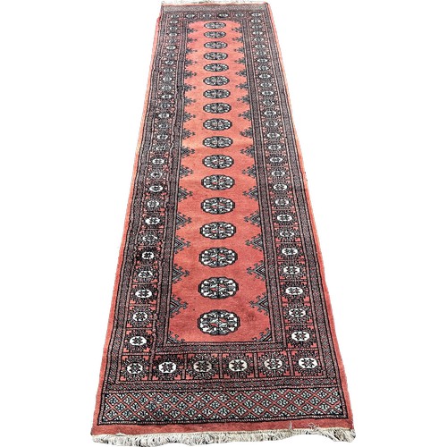 1618 - An Afghan runner with a central row seventeen small elephant foot gul, 280cm x 80cm approximately