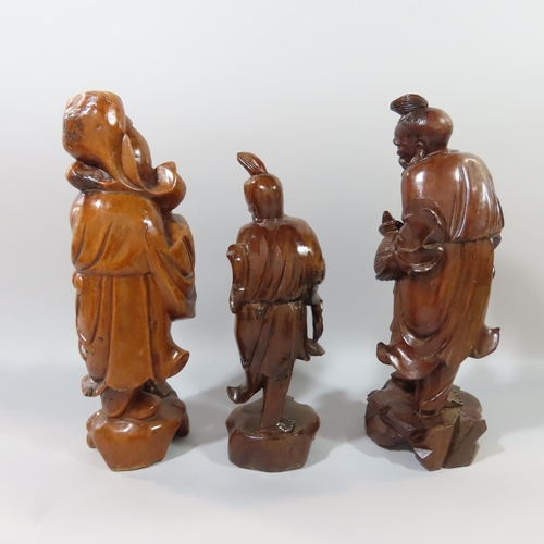 362 - Nine Chinese hardwood carvings of Sages, Craftsmen, Farmers, Fishermen etc