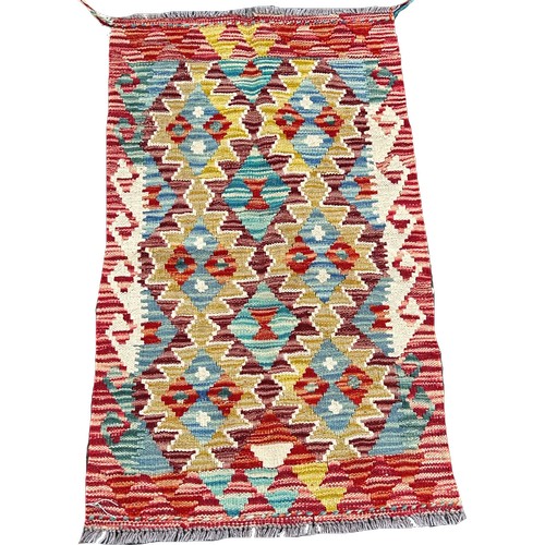 1632 - A Chobi Kilim mat with interlocking stepped medallions, 94cm x 56cm approximately