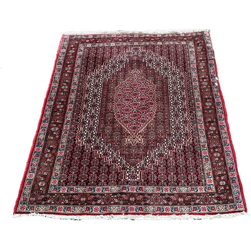 1633 - A Persian carpet with a radiating all over floral pattern, 150cm x 120cm approximately.