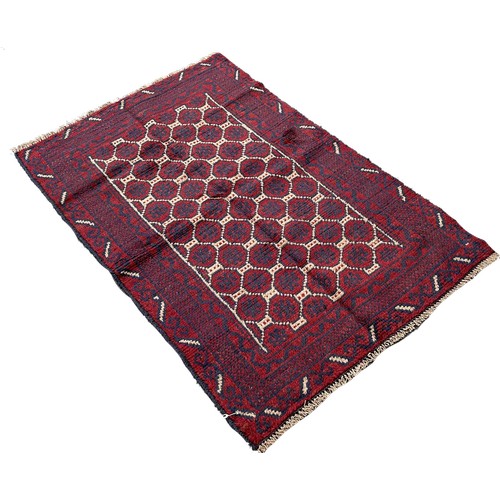 1644 - A Baluchi rug with a field of geometric hexagons,  127cm x 80cm approximately