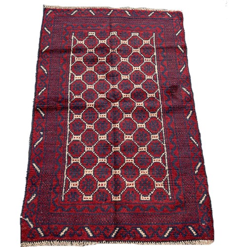 1644 - A Baluchi rug with a field of geometric hexagons,  127cm x 80cm approximately