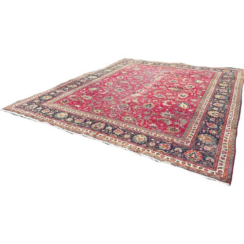 1649 - A large country house Persian wool carpet with a large all over floral pattern on a red ground with ... 