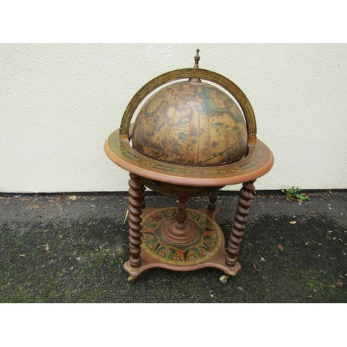 1490 - A reproduction globe cocktail cabinet with paper finish in the old world style raised on barley twis... 