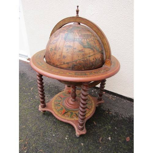 1490 - A reproduction globe cocktail cabinet with paper finish in the old world style raised on barley twis... 