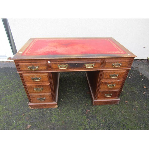 1506 - A Victorian oak pedestal desk of nine drawers with brass plate handles and inset leather top, 122cm ... 