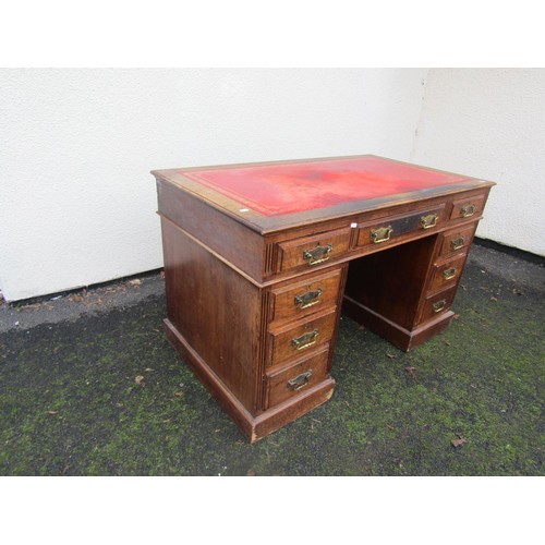 1506 - A Victorian oak pedestal desk of nine drawers with brass plate handles and inset leather top, 122cm ... 