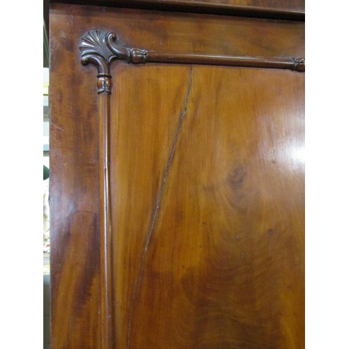 1514 - An Victorian flamed mahogany inverted breakfront triple wardrobe enclosed by a series of cupboards, ... 