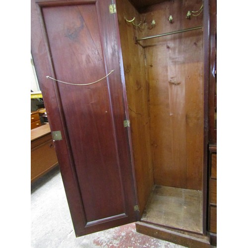 1514 - An Victorian flamed mahogany inverted breakfront triple wardrobe enclosed by a series of cupboards, ... 