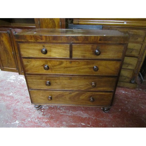 1518 - A mahogany chest of two short and three long drawers on bun feet, 107cm wide