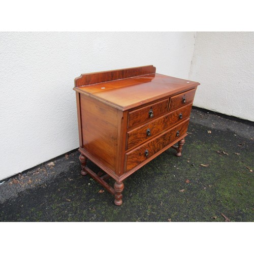 1522 - A walnut chest of two long and two short drawers on turned supports, 90cm wide