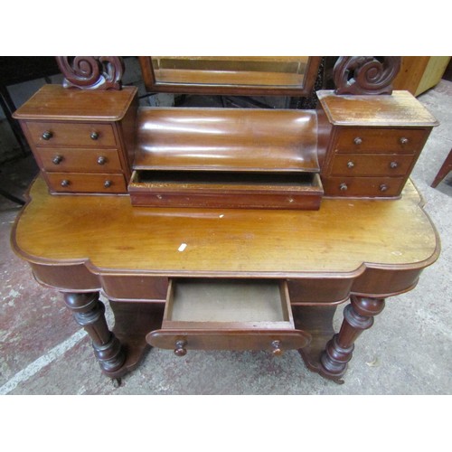 1523 - A Duchess style mahogany dressing table on turned supports