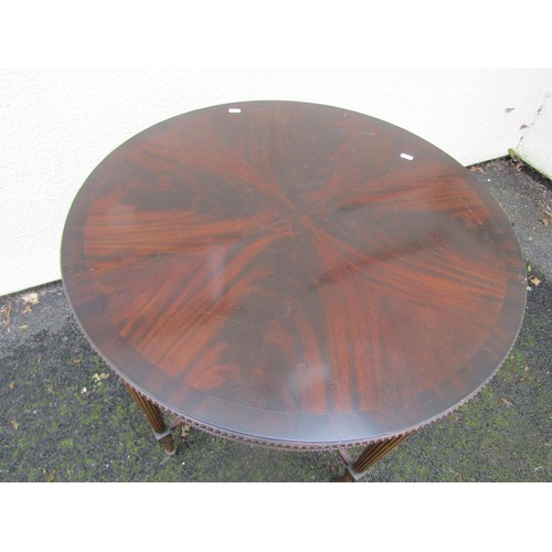 1530 - A good quality reproduction mahogany two tier occasional table of circular form on fluted supports, ... 