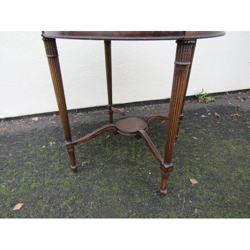 1530 - A good quality reproduction mahogany two tier occasional table of circular form on fluted supports, ... 