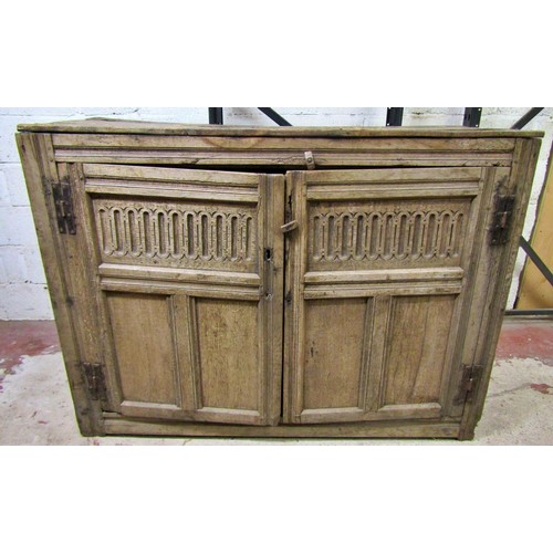 1535 - A large early oak side cupboard, with hinged panelled doors enclosing a shelved interior, 113cm high... 