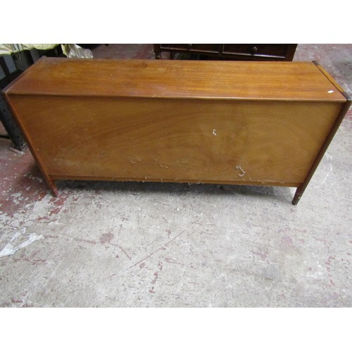 1543 - A mid 20th century teak sideboard enclosed by two sliding doors with two drawers, 160cm wide