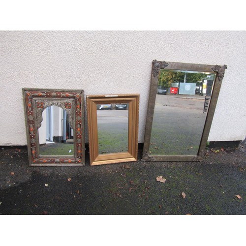 1544 - A Mexican hammered wall mirror with applied detail, further gilt framed mirror and one other