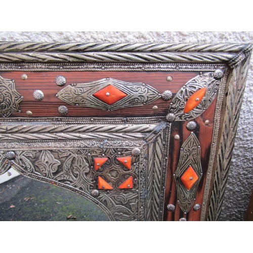 1544 - A Mexican hammered wall mirror with applied detail, further gilt framed mirror and one other