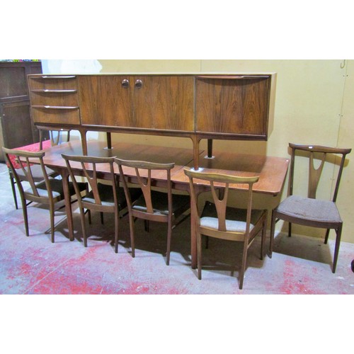 1549 - An AH McIntosh rosewood dining room suite comprising an extending dining table with two additional l... 