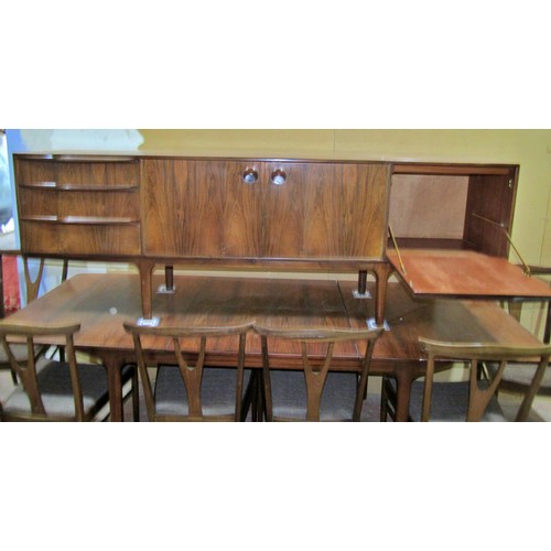 1549 - An AH McIntosh rosewood dining room suite comprising an extending dining table with two additional l... 