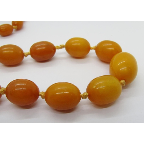 273 - Graduated amber coloured bead necklace, largest bead 2 x 1.5cm approx, 41g (one bead af)