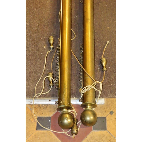 1076 - A pair of Victorian brass curtain rails/poles with sphere finials, sliding track and weight draw cor... 