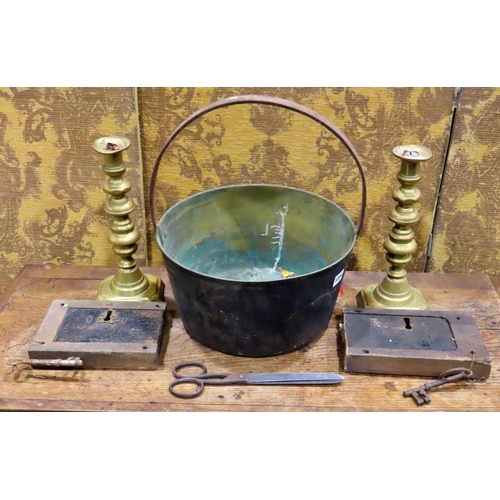 1094 - A 19th century jam pan, two large brass candlesticks, two oak locks, etc