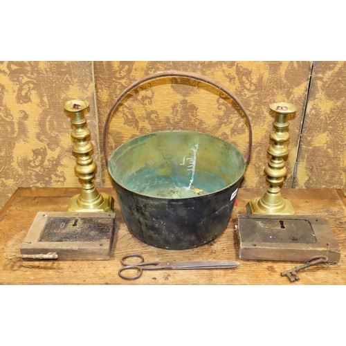 1094 - A 19th century jam pan, two large brass candlesticks, two oak locks, etc