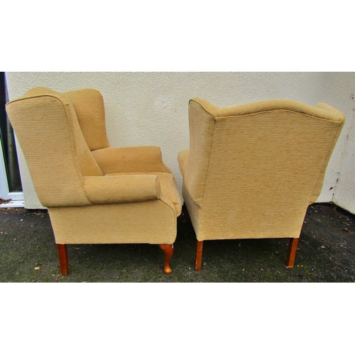 1487 - A Pair of Georgian style wing chairs in a pale mustard upholstery on cabriole supports, together wit... 