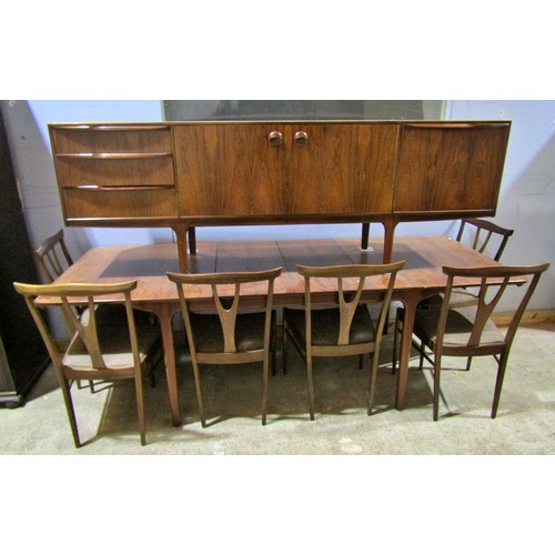 1549 - An AH McIntosh rosewood dining room suite comprising an extending dining table with two additional l... 