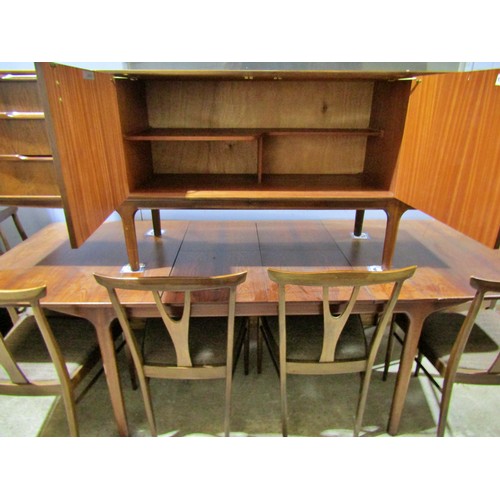 1549 - An AH McIntosh rosewood dining room suite comprising an extending dining table with two additional l... 