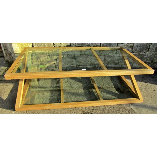 1328 - A contemporary oak framed plate glass topped occasional table, with X framed supports and glass unde... 