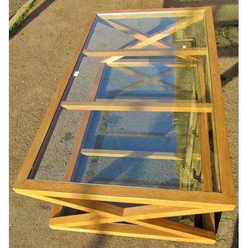 1328 - A contemporary oak framed plate glass topped occasional table, with X framed supports and glass unde... 